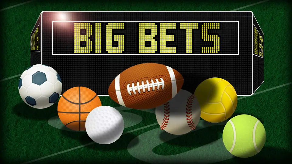 Stadium scoreboard reading BIG BETS above a football, basketball, rugby ball, baseball, golf ball, volleyball and tennis ball on grass